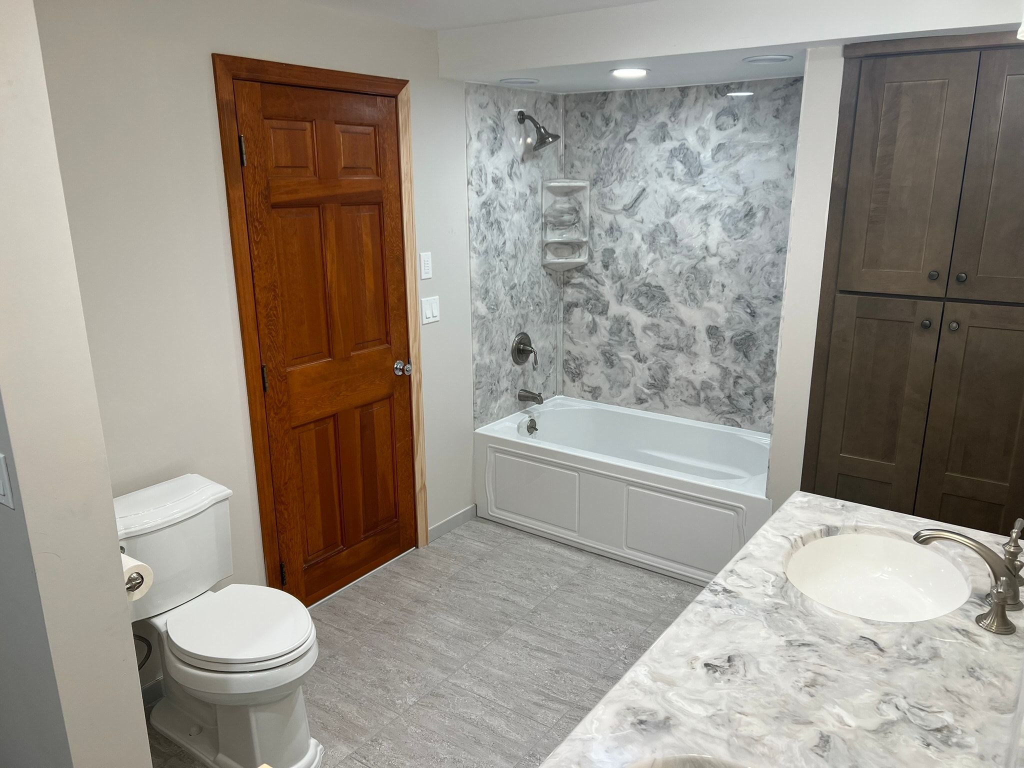 Bathroom renovation — finished room with marble vanity and tile surround, Eastern Connecticut