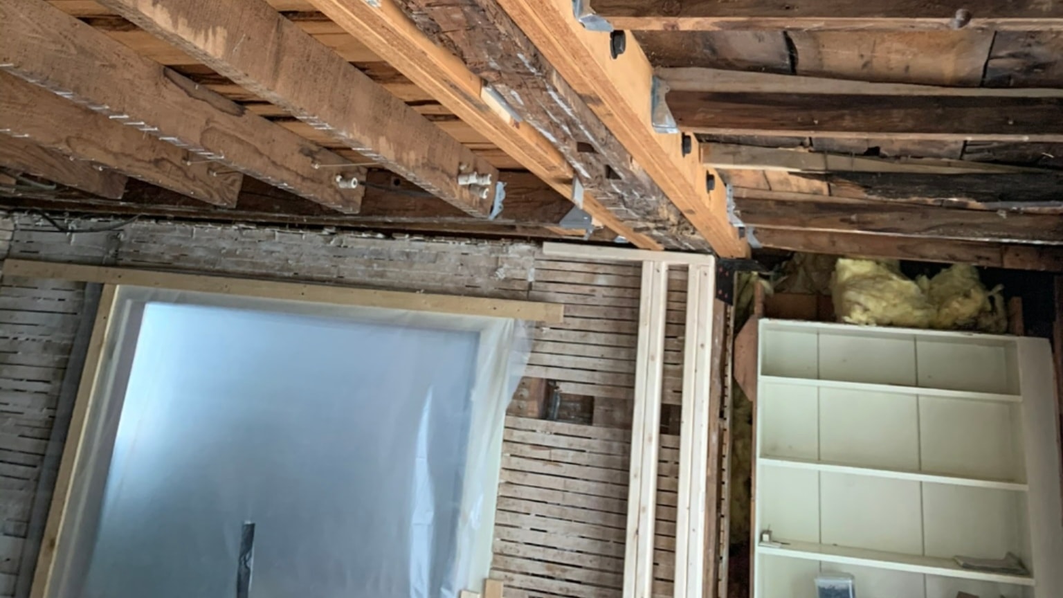 Historic living room restoration with burgundy beams by Sunrise Construction