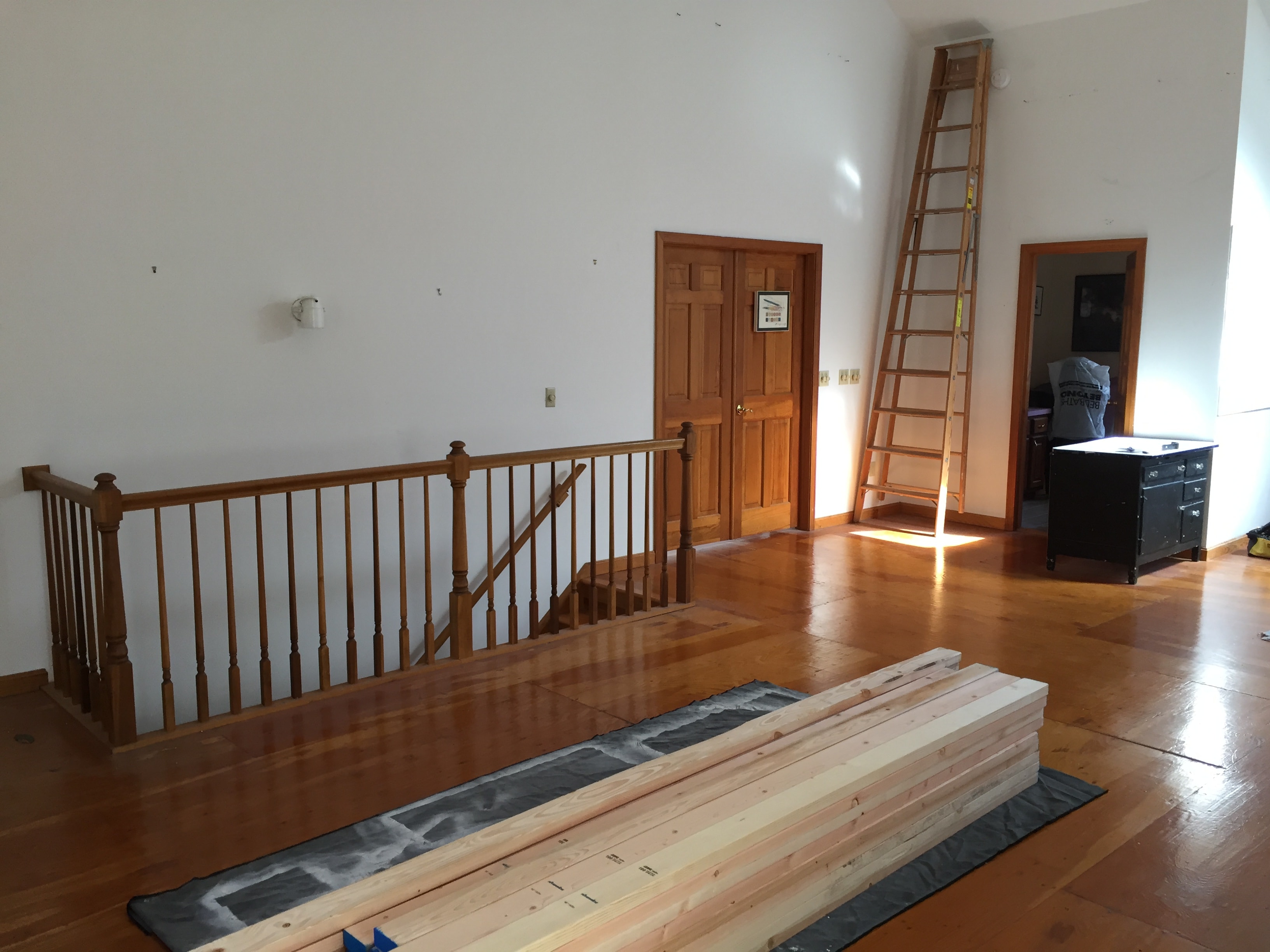 Separation wall framing with art storage loft and library ladder — Eastern Connecticut