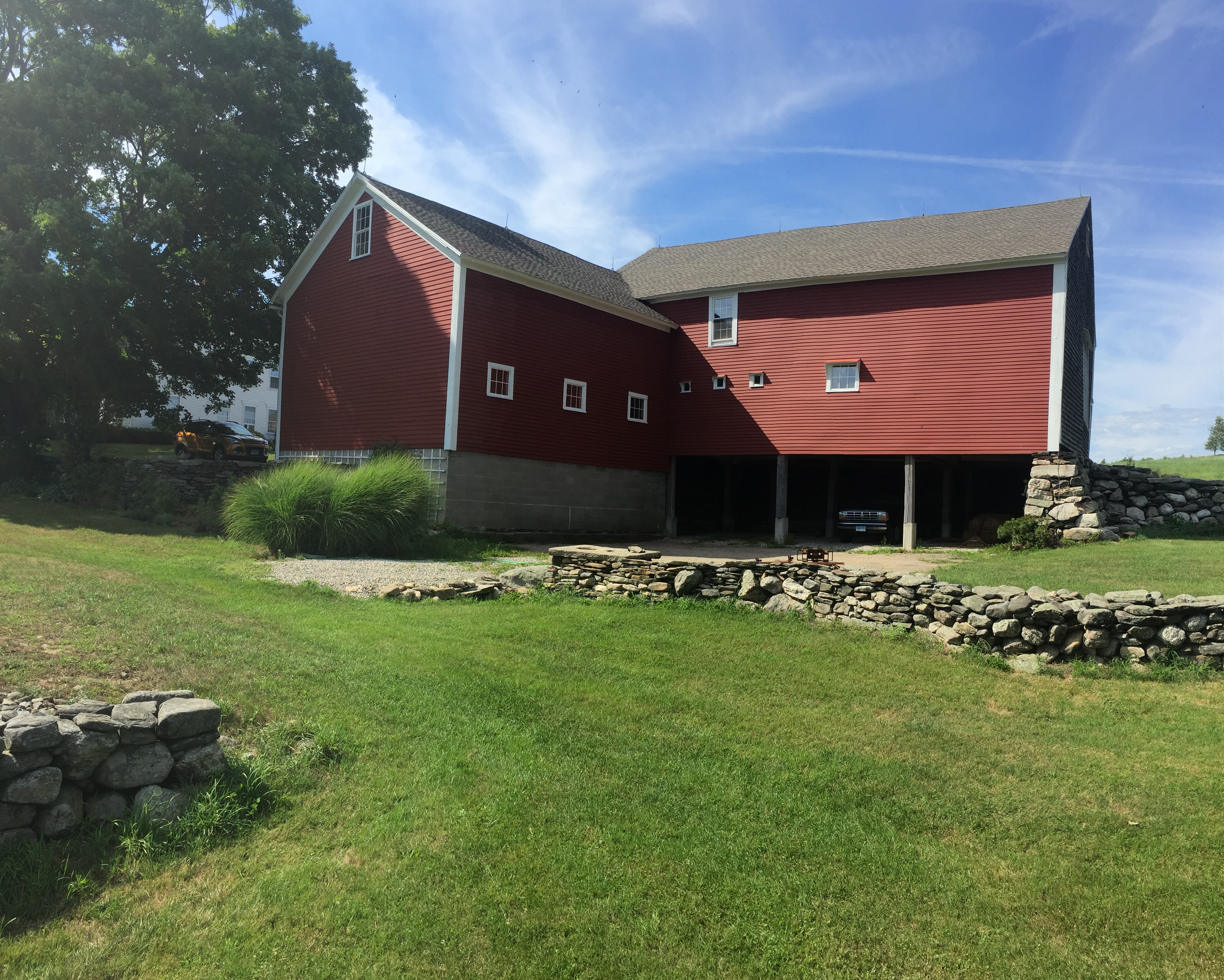 Red barn with stone foundation before restoration — Eastern Connecticut
