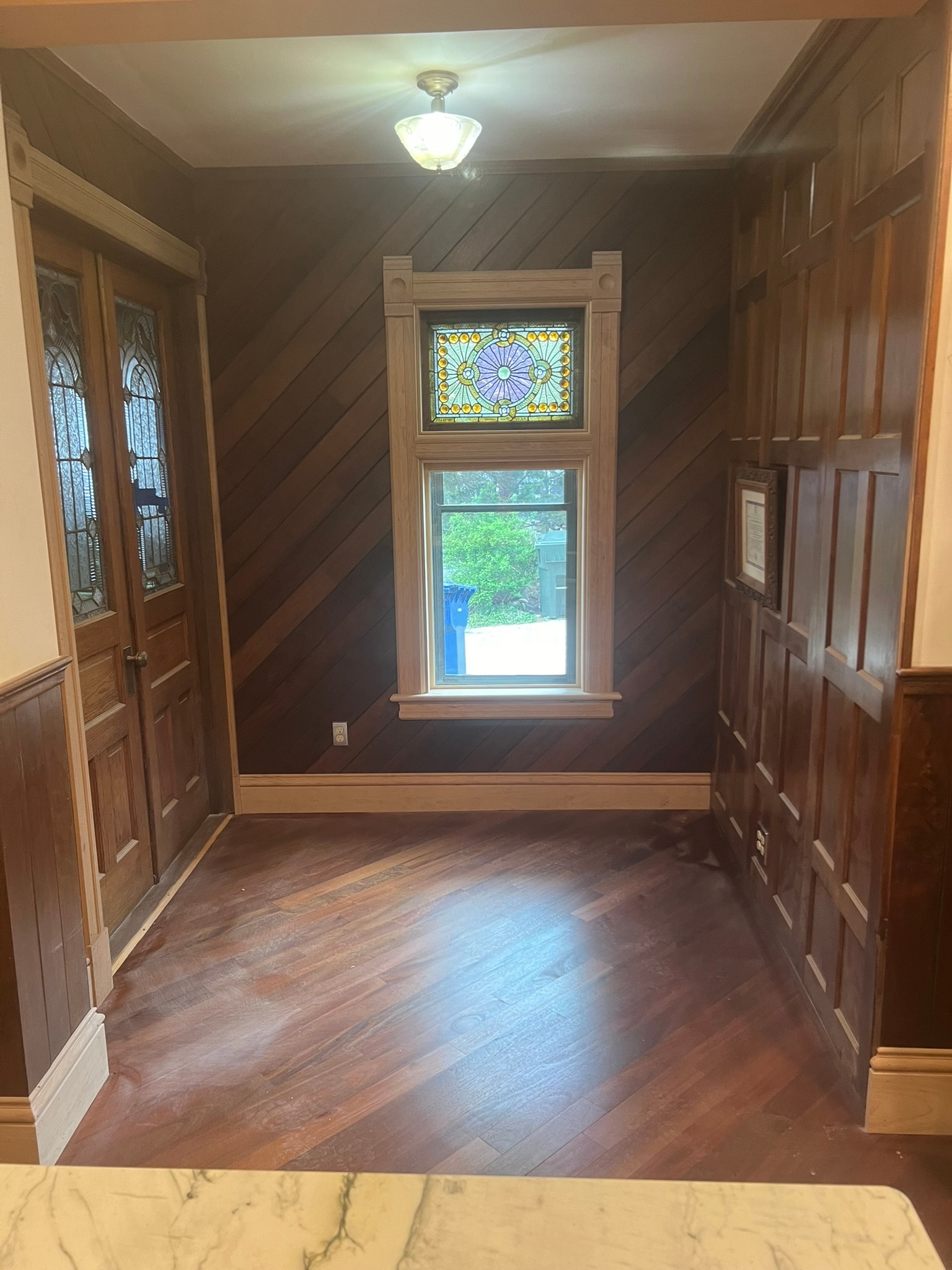 Victorian kitchen restoration — stained glass transom window and salvaged wainscotting from NY mansion