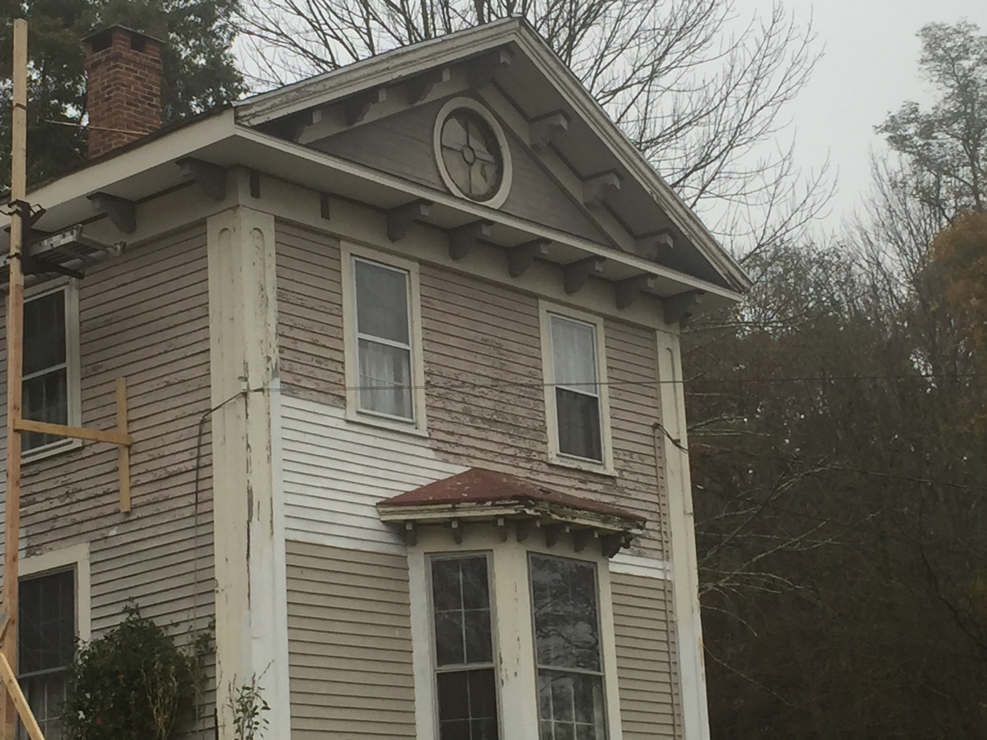 Original Victorian corbels removed and laid out on lawn before repainting
